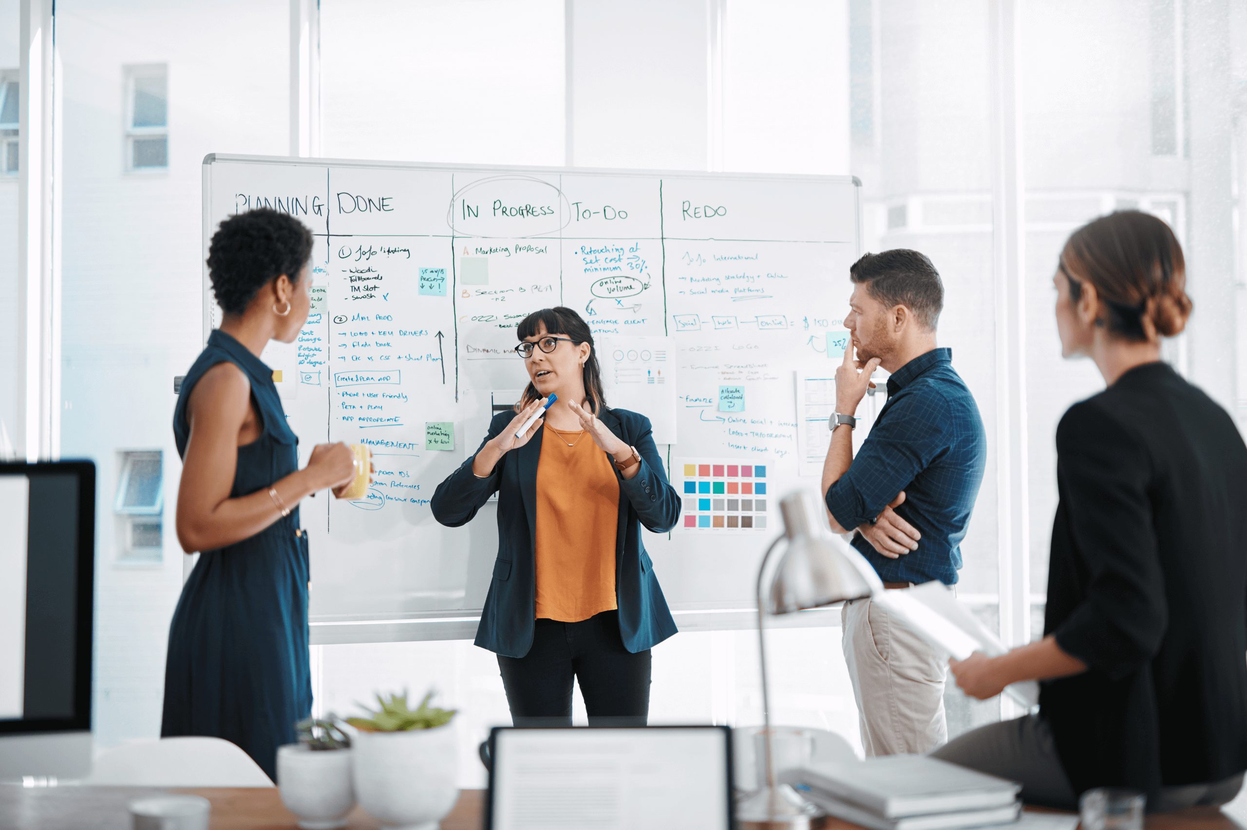 Four employees are having a huddle