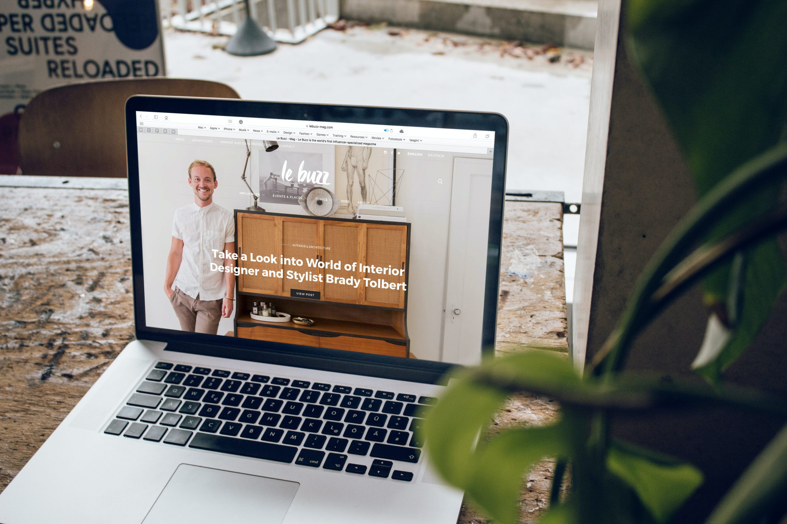 A desktop showing the website portfolio placed on a wooden table