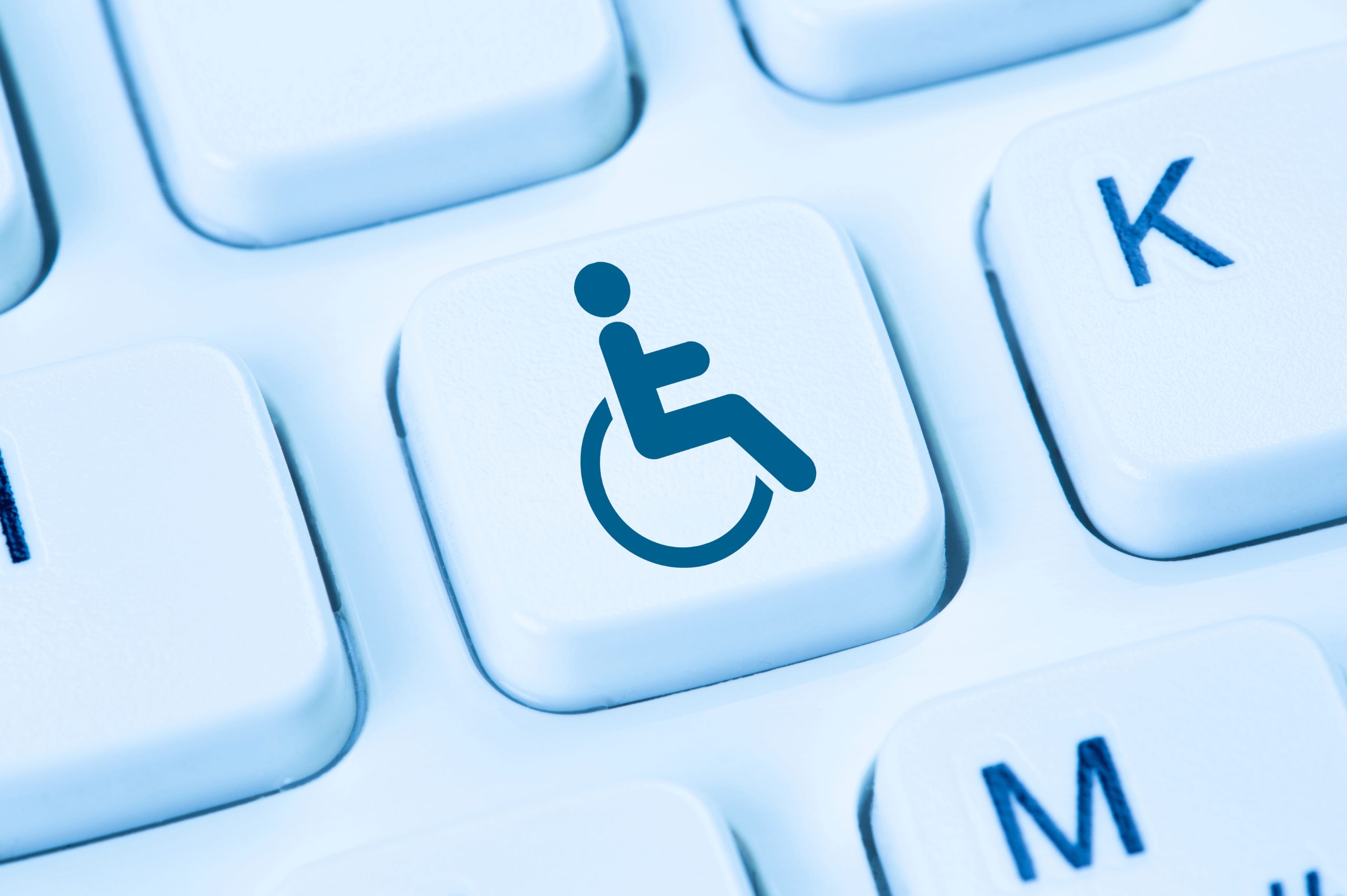 A keyboard close-up with accessibility symbol key represents user-friendly websites through web accessibility