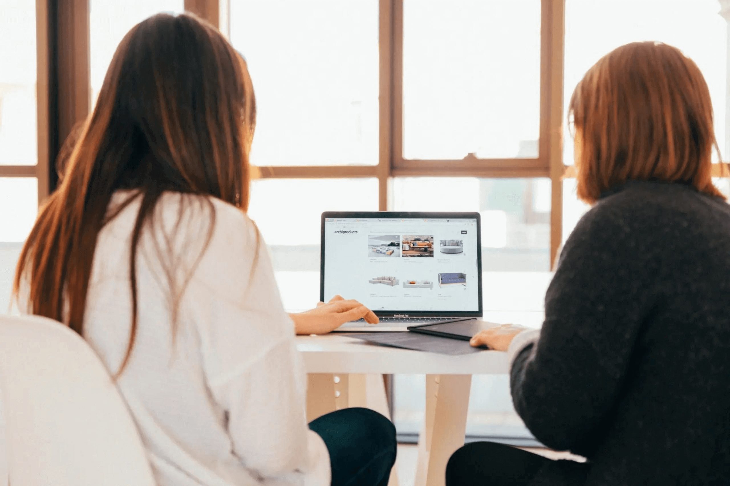 Two women checking out a website