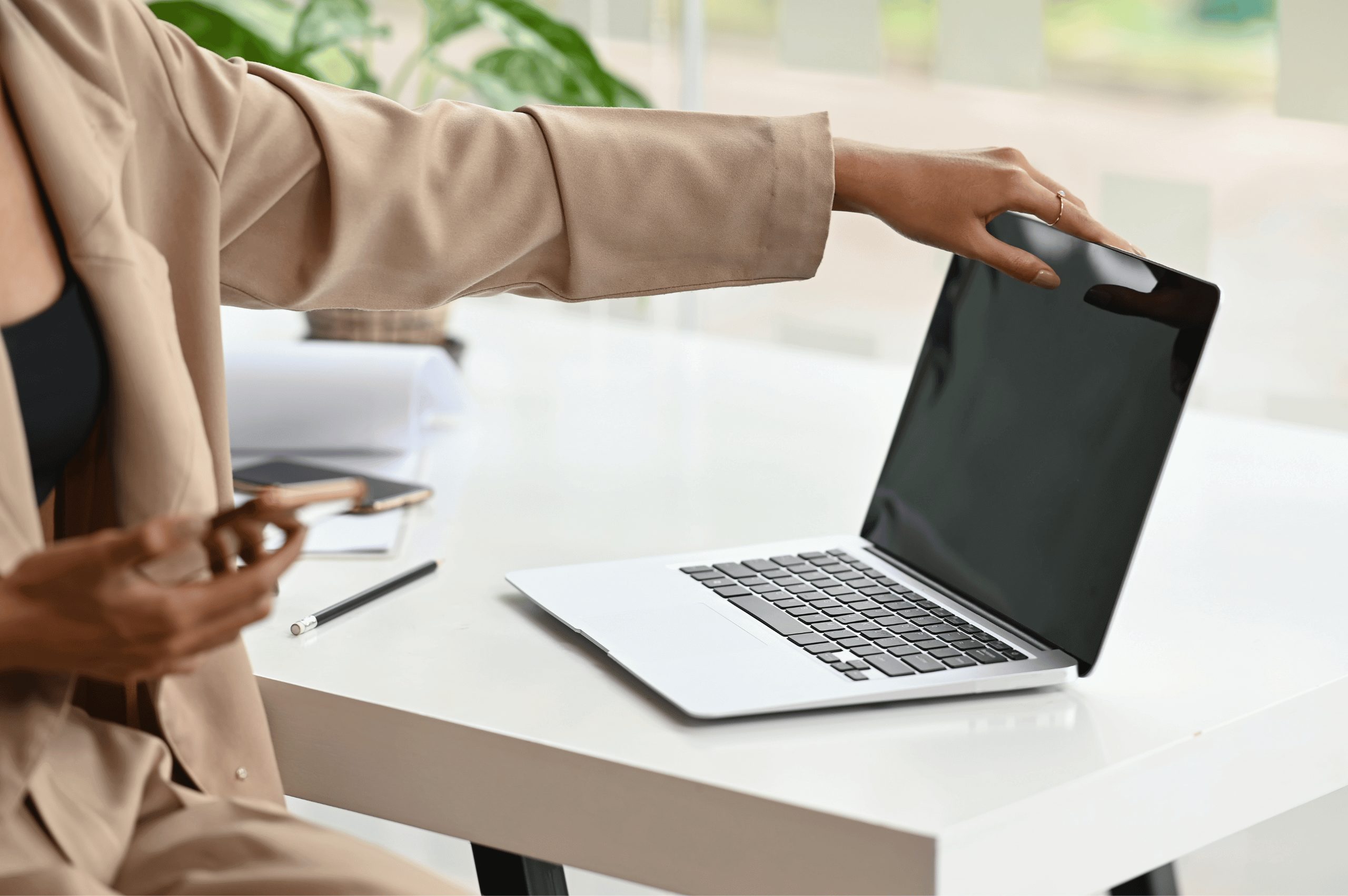 A woman closing her laptop